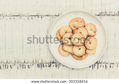 Danish butter Cookies in white ceramic dish on wood table with vintage style