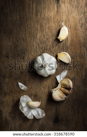 Organic garlic bulbs on rustic wooden background, Still life photography with garlics on wooden background, The art of food photography with organic garlics