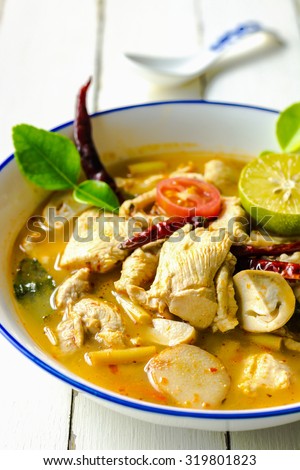 Tom yum soup, Thai spicy chicken soup, Thai popular food menu on wood table background, Food photography with spicy chicken soup