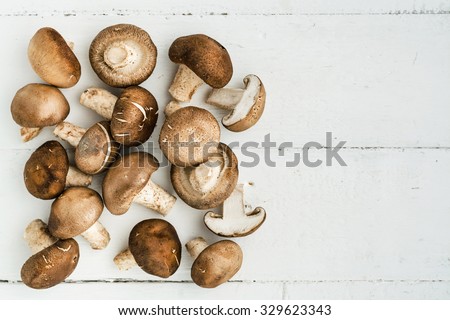 Top view of mushrooms on wooden background