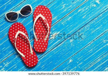 Summer holiday background, Beach accessories on white wood table, Vacation and travel items, Red flip flop with sunglasses on wood table