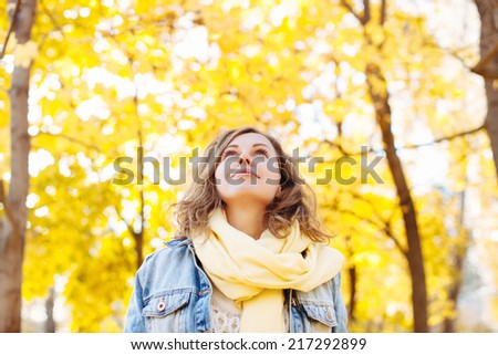 Beautiful woman in autumnal park