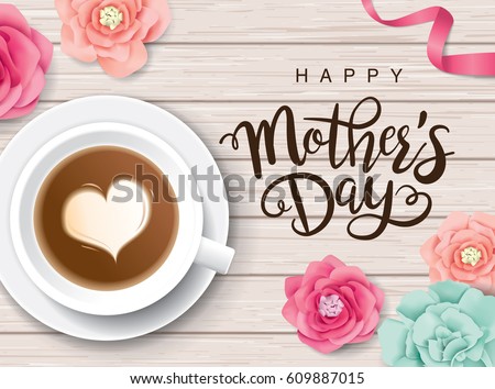 Flat lay style mother\'s day greeting card with coffee cup and flowers on wooden table.