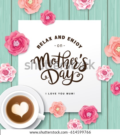 Flat lay style mother`s day greeting card with coffee cup and flowers on wooden table.