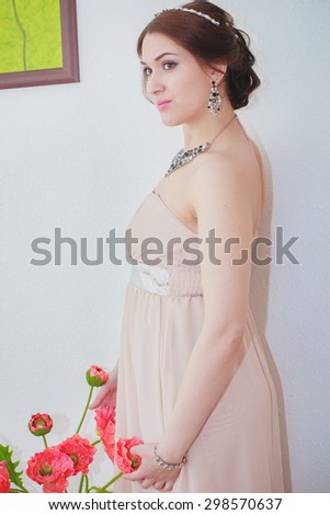 beautiful girl with sparkling jewelry and perfect skin is waiting for her wedding with flowers
