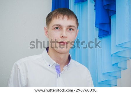 a young man in a shirt in anticipation of the wedding with his beloved