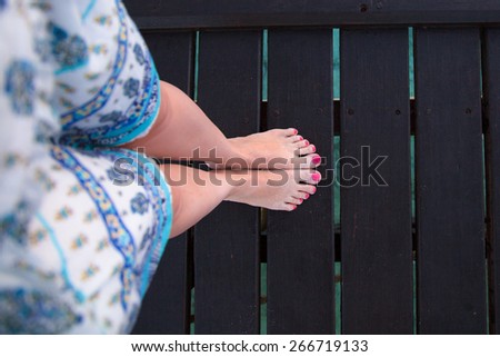 Bare feet girls on wooden bridge view from above