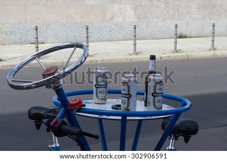 Berlin, Germany - August 01, 2015 :German beer cans on beer bike. Residents and drivers complain about the noisy, traffic-clogging groups on so called Bierbikes (beerbikes).