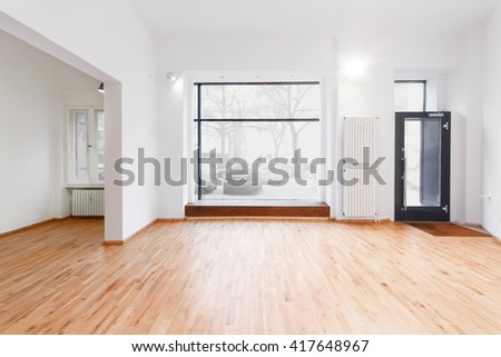 renovated room with shopping window - empty store / shop with wooden floor and white walls