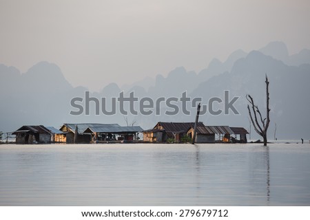 Fisherman Village on the lake, Thailand. People do live and make a living any place possible. This is a typical Thai fisherman village located on water in a damn area.