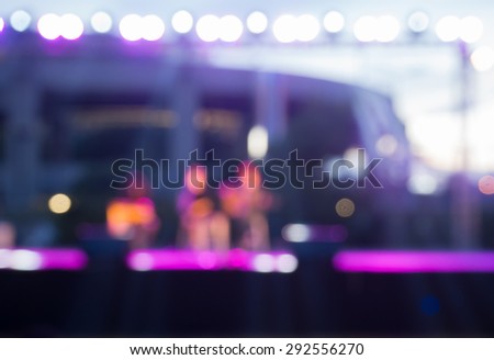 Blurry singers on stage in the outdoor concert