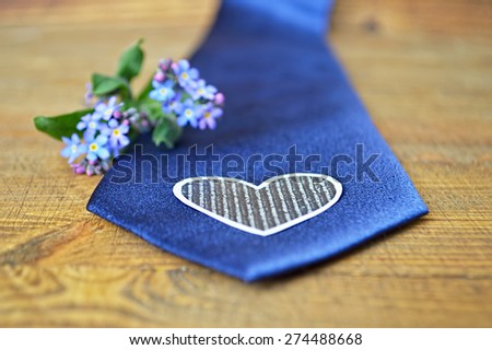 Father\'s Day gift - spring flowers and blue tie on wooden background