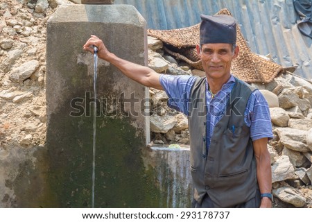 SIPAGHUT, NEPAL - JUNE 20:Unidentified man with tap water on June 20,2015 in Sipaghut bazaar,Nepal