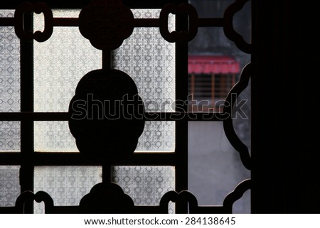 Geometric shaped window with frosted textured glass partially open.