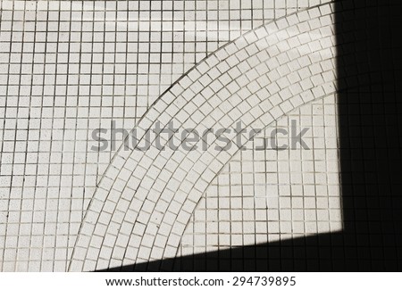 Strong building shadow cast on ground tiles
