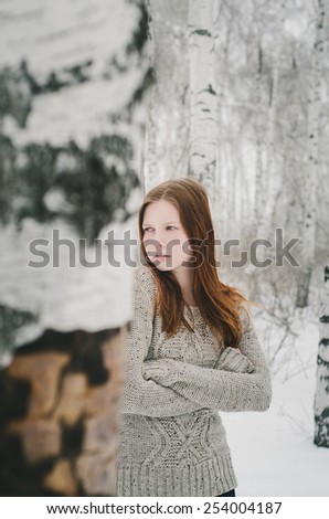 Ginger hair girl in winter forest