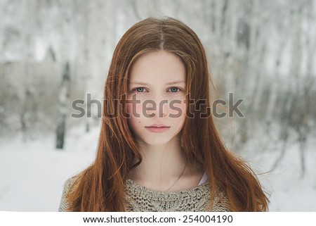 Ginger hair girl in winter forest