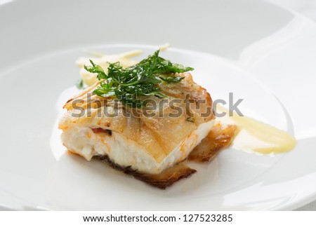 cooked fish piece on white plate