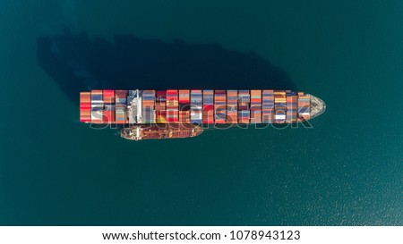 Top view of a large loaded container ship and a tanker standing side by side.