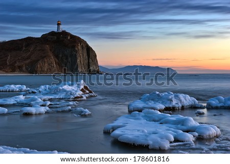 Winter sea landscape with a beacon on cape Brinera. The Far East. Russia.