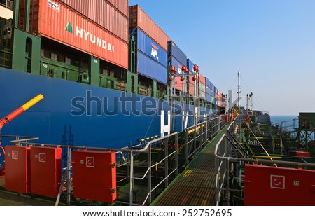 Bunkering at sea a huge container ship Hyundai companies. Nakhodka Bay. East (Japan) Sea. 19.04.2014