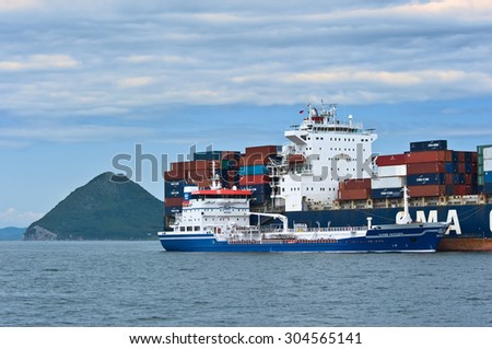 Bunkering tanker Zaliv Nakhodka a large container ship CMA CGM Marlin. Nakhodka Bay. East (Japan) Sea. 02.08.2015