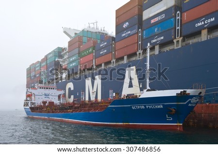 Bunkering tanker Ostrov Russkiy a large container ship CMA CGM Gidra. Nakhodka Bay. East (Japan) Sea. 22.07.2015