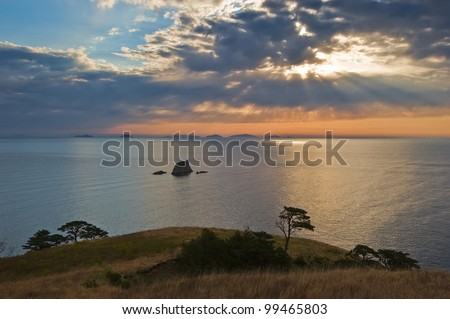 Spring morning seascape with beautiful rays of the sun, illuminating the sea. Japan Sea.