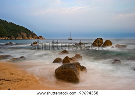 Evening landscape with sea surf and boat in the middle of the bay. Japan Sea.