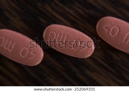 Aerial view of 40mg red pills on wood background
