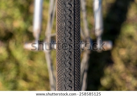 Close up Symmetry Bicycle Tire on Green Grass background