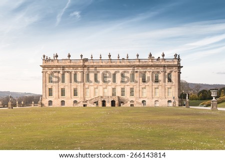 Bakewell, UK - April 2, 2015: Chatsworth House Front View took from the Garden in Bright Blue Sky. This Old European Style House is located in Peak District, Derbyshire.