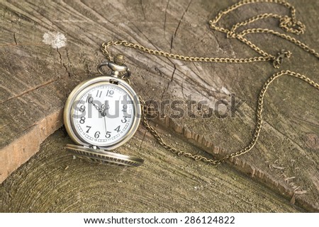 Old-fashioned Golden Watch with Opened lid on wood
