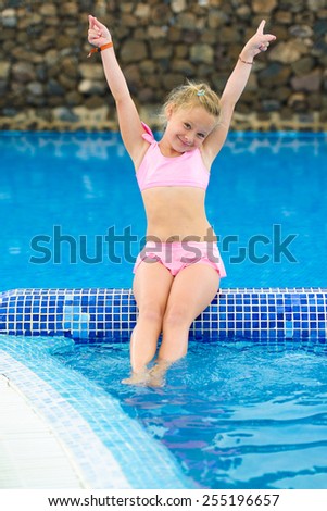 Funny little girl in the swimming pool
