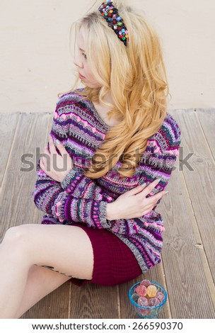 Woman in knitted sweaters on a beach pose