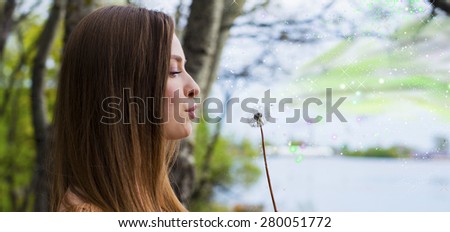 The woman blows on a dandelion, waiting for summer,Make the wish