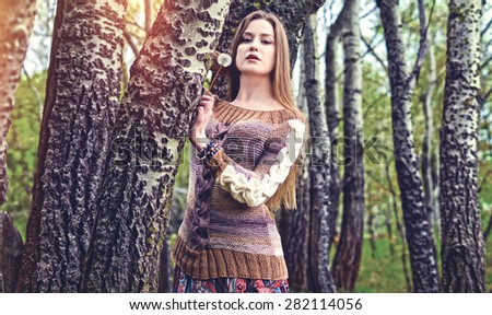 The girl got lost among big trees, a fairy forest,woman posing