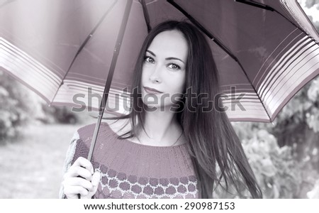 Rainy day, sad mood, the woman with an umbrella