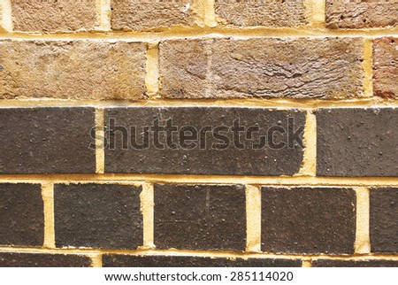 Red and  dark brown abstract close-up brick wall background