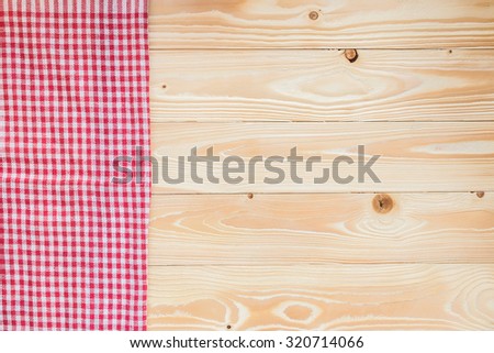 wood texture with red squared textile napkin, top view, horizontal