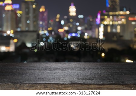 Wood floor with blurred abstract background of city night lights downtown city view : Wooden table with blur background of cityscape