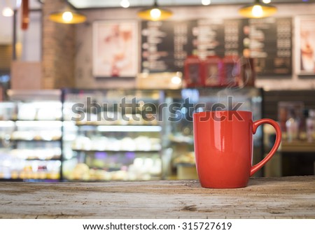 wooden table with bakery shop or coffee cafe blurred background