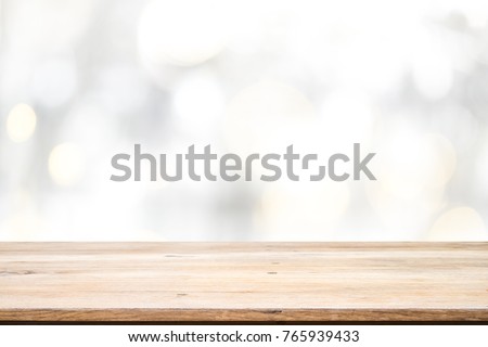 Wood table top on white bokeh abstract background and used for montage or display products