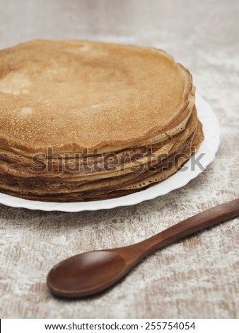 Russian pancakes with wooden spoon on wooden table. Russian cuisine. Taste pancake. Blini. Maslenitsa. Pancake week. Butter Week. Cheesefare Week