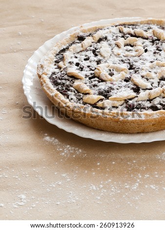 Blackberry and blueberry pie. black currant pie in vanilla powder. Powdered sugar. Blackberry cake on desk. Bake with vanilla powder. Baking
