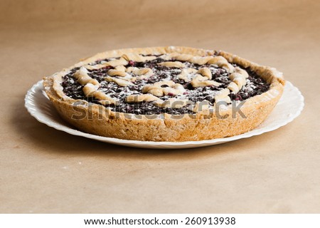 Blackberry and blueberry pie. black currant pie in vanilla powder. Powdered sugar. Blackberry cake on desk. Bake with vanilla powder. Bake