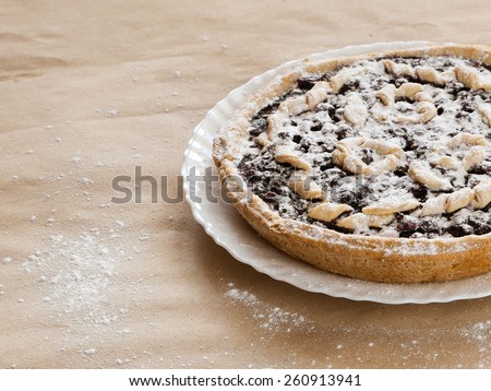 Blackberry and blueberry pie. black currant pie in vanilla powder. Powdered sugar. Blackberry cake on desk. Bake with vanilla powder