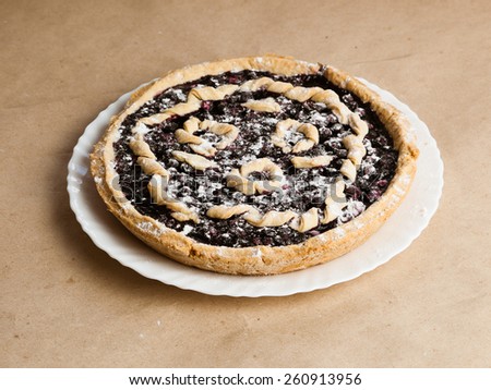 Blackberry and blueberry pie. black currant pie in vanilla powder. Powdered sugar. Blackberry cake on desk. Bake with vanilla powder. Baking