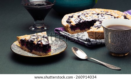 Cup of tea and blackberry pie. black currant pie in vanilla. Cup of tea with blackberry jam, confiture. powdered sugar. Piece of cake. Bake