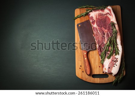 Meat pork fresh. Raw meat on cutting board. Rosemary spice and meat. Axe and meat pig. Fat piece